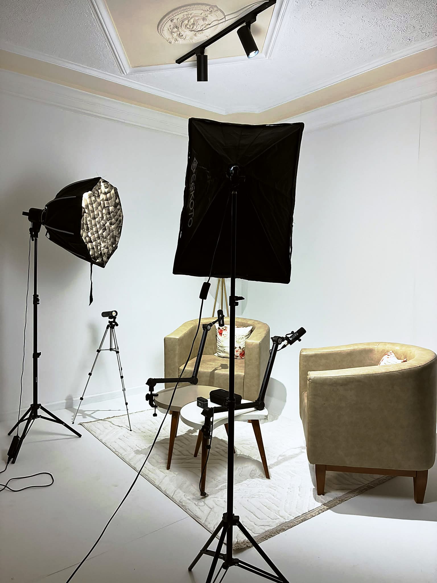 Softbox and octabox lights over two armchairs set up for a podcast