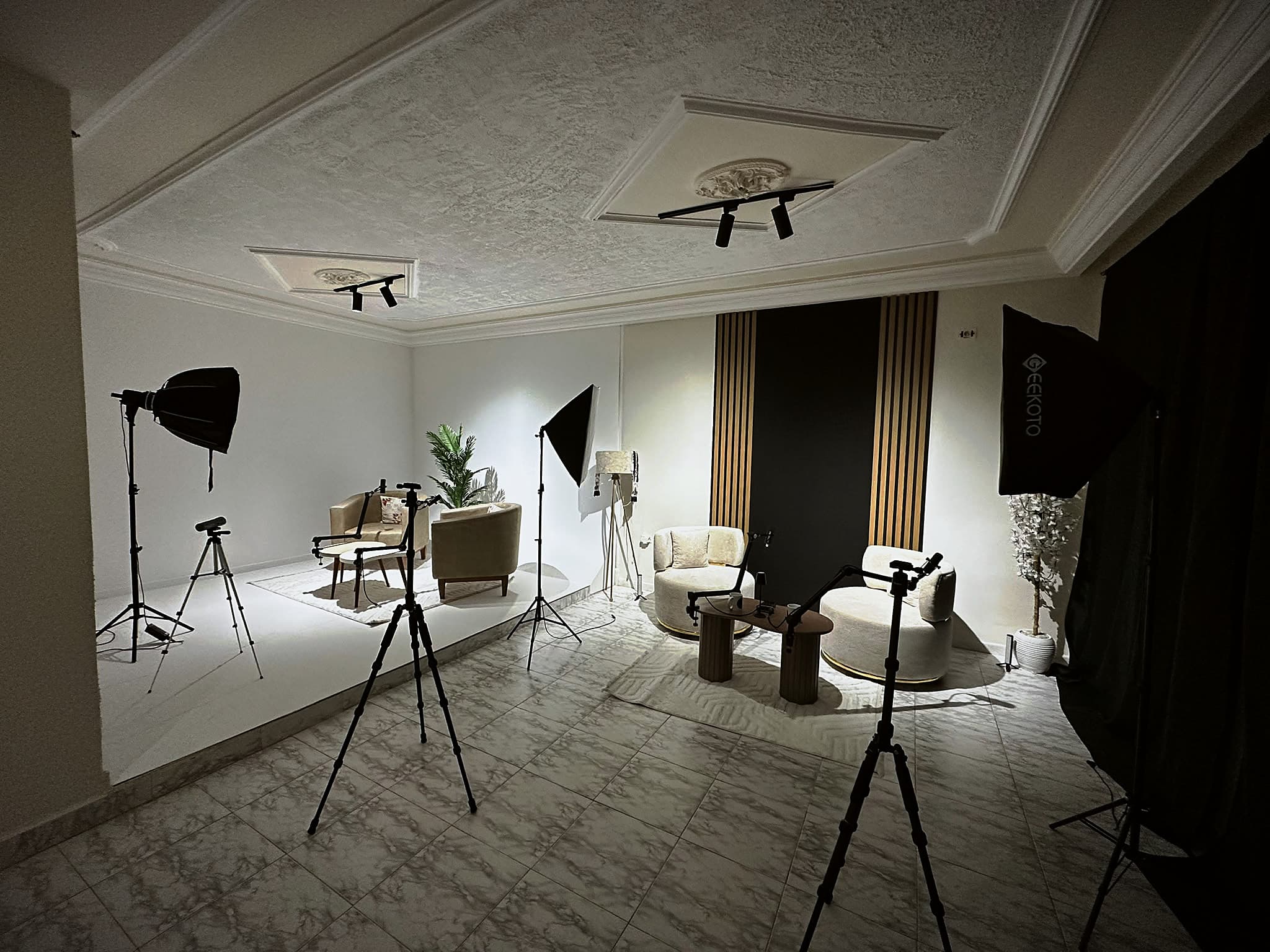 The Tunisia Studios set: lounge chairs, softboxes, cameras on tripods and black drapes