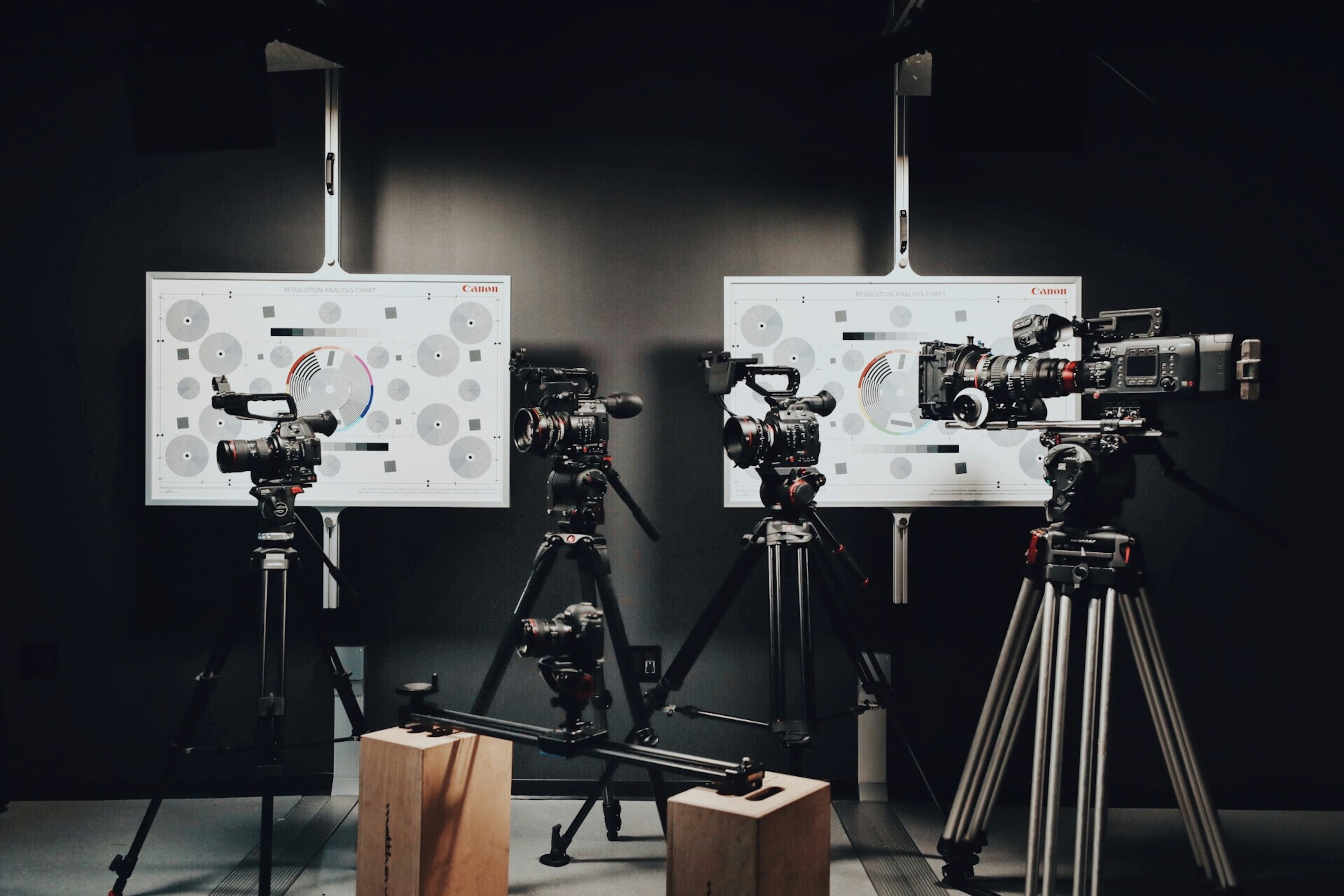 Video and photo cameras mounted on tripods